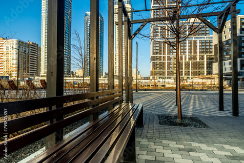 A bench in the city square in close-up.