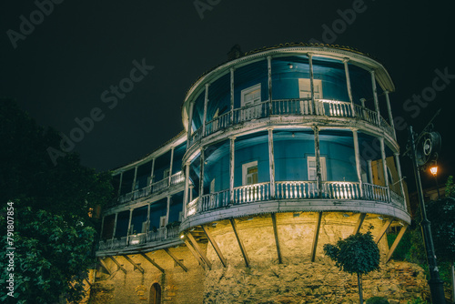 Old traditional Georgian house with wooden balcony in old Tbilisi (Georgia) by night