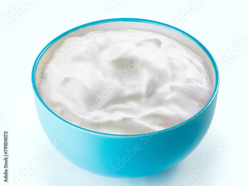 cream sour in  blue bowl isolated white background