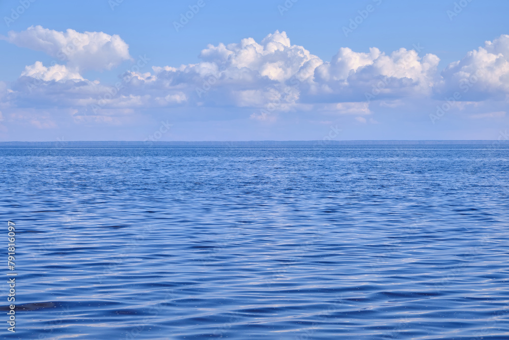 Obraz premium Blue sea and white clouds on sky.