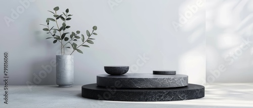 A sleek modern display featuring a dark, circular stone platform with a vase and bowls, highlighted by soft natural light and shadows.
