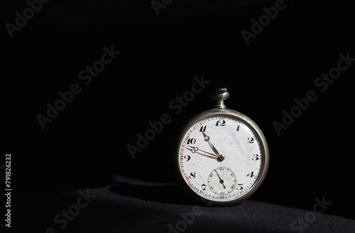 Old silver pocket watch isolated on black background. Time concept, antique object