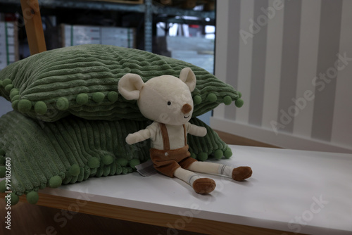 Plush mouse on pillows as decoration