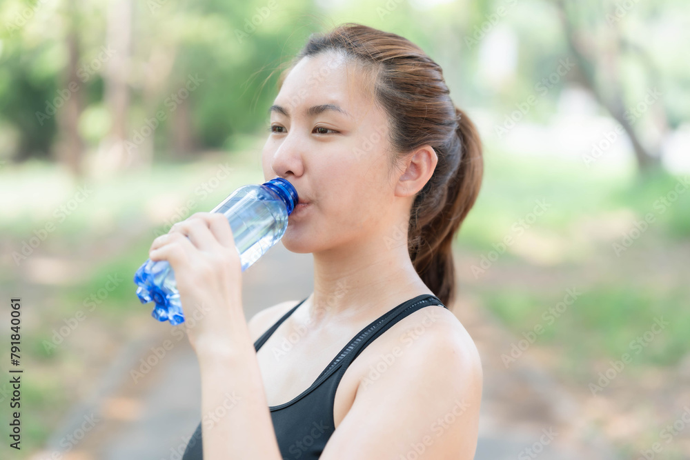 Asian woman drinking water after jogging. Health care concept. Drinking enough water per day. Asian woman drinking water after jogging. Health care concept. Drinking enough water per day.