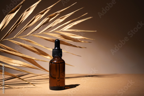 Dropper cosmetic oil bottles with dry palm leaf. Natural organic cosmetic, eco lotion, essence, serum. Aromatherapy.