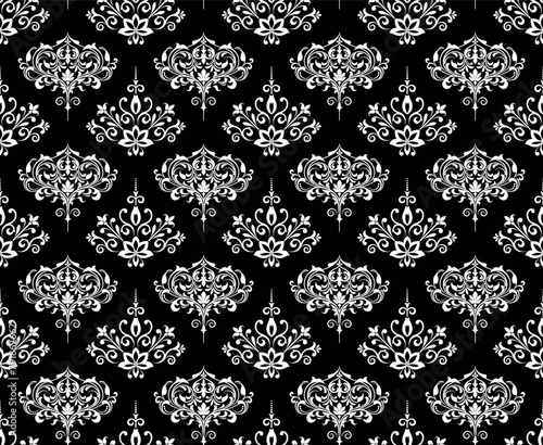 Wallpaper in the style of Baroque. Seamless vector background. White and black floral ornament. Graphic pattern for fabric, wallpaper, packaging. Ornate Damask flower ornament.