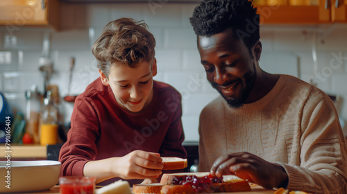 happy african american father and son having breakfast in kitchen at home