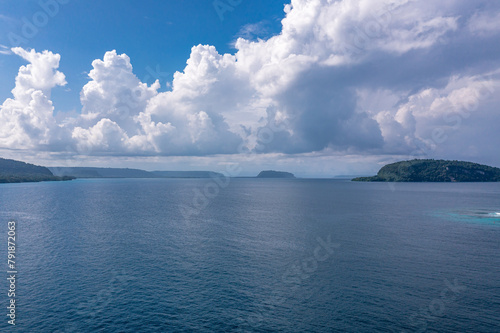 Soothing seascape with cumulus white clouds and part of island. Sanma, Vanuatu is tourist paradise.