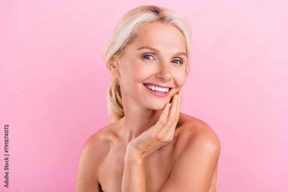 Photo of lovely adorable retired lady nude shoulders enjoying her perfect young skin isolated on pink color background Photo of lovely adorable retired lady nude shoulders enjoying her perfect young skin isolated on pink color background