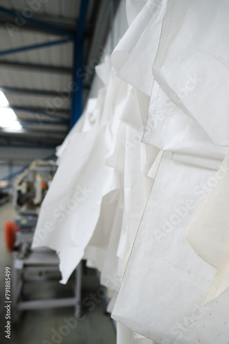 Jeans denim and cotton cutting templates in a fabric textile factory. Designs and cutting templates in an industrial setting. Mapping out shapes of jeans for the fashion industry.