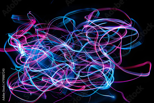 Energetic neon pink and blue lines dancing in chaotic harmony. Captivating artwork on black background.