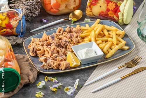 Fotografi Fried squid, also known as calamari, are sliced into rings, lightly battered, and deep-fried until crispy