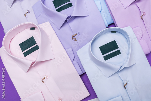 Background of colorful folded shirts, top view