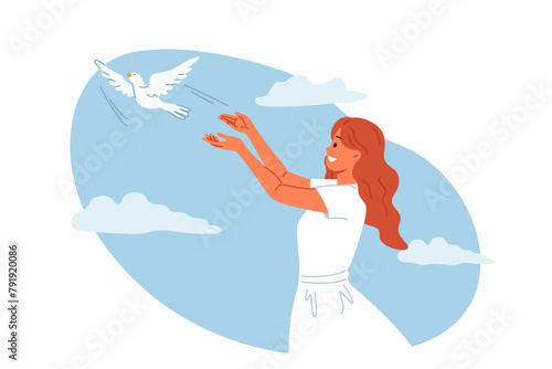 Woman launches dove into sky, symbolizing peace and harmony or hope for better future for people. Dove bird takes off from hands of religious girl, experiencing joy in communicating with animal world