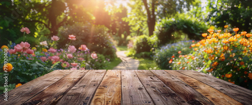 Wooden table in a lush garden with flowers and trees in the background