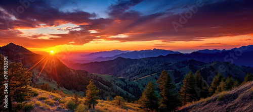 Breathtaking mountain landscape at sunset, with the colorful sky painting a stunning backdrop. © EdNurg