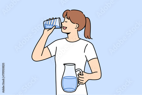 Woman drinks clean water from glass to refresh herself and saturate body with mineral aqua with vitamins. Girl with jug of water in hands, taking care of health, trying to avoid dehydration