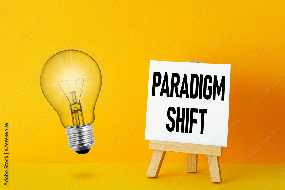 Paradigm Shift is shown using the text and photo of light bulb - obrazy, fototapety, plakaty 