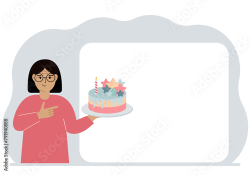 A woman holds a cake in his hand. Nearby is a white poster for text. Birthday or holiday.