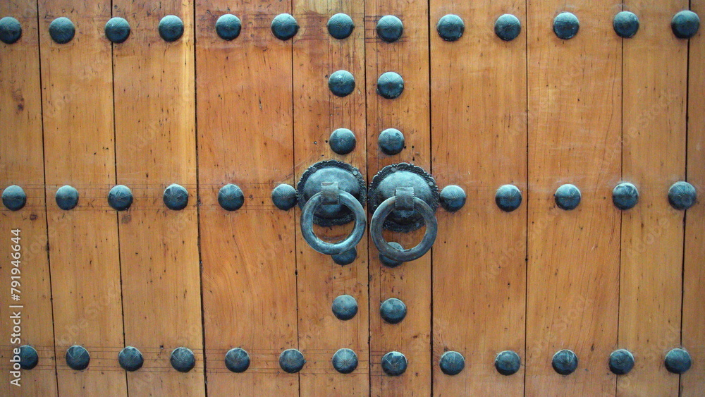 Handle on the wooden doors of a mosque in Fes, Morocco Handle on the wooden doors of a mosque in Fes, Morocco