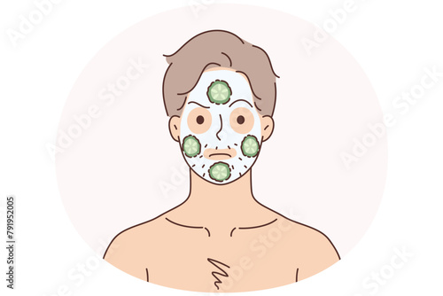 Man do face mask with cucumbers