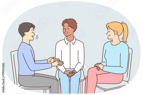 Smiling people sit in circle talking