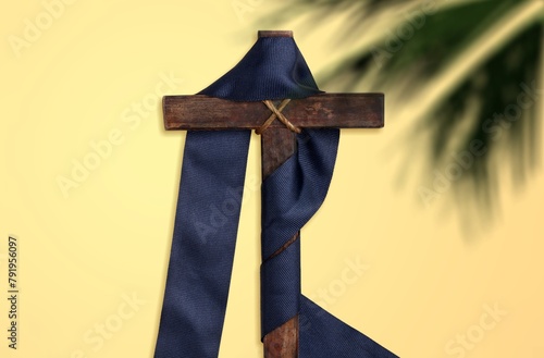 Wooden cross and palm leaf on background