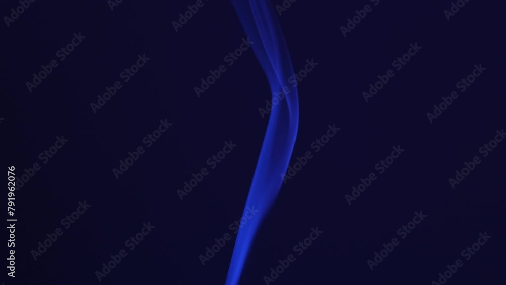 Smoke incense stick close-up on a dark background Smoke incense stick close-up on a dark background