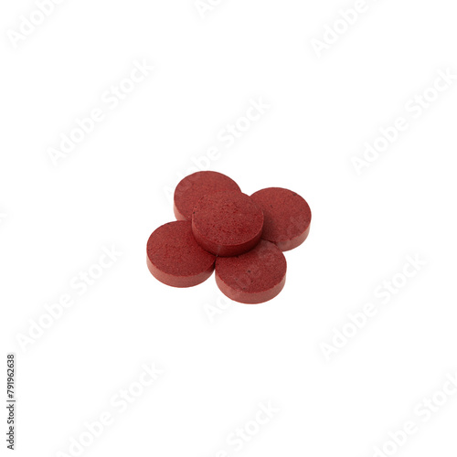 Red pigments in the form of tablets on white background. Food additive E129, allura RED AC. Dyes for coloring food products and also easter eggs