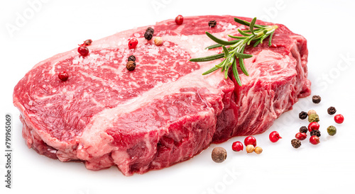 Raw ribeye steak with pepper corns and rosemary isolated on white background. © volff