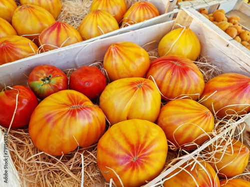 Yellow beefsteak tomato or beef tomato close up on the farm market stall. Food background.