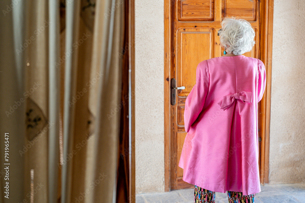 Portrait of a white-haired woman in her sixties dressed elegantly in fashion