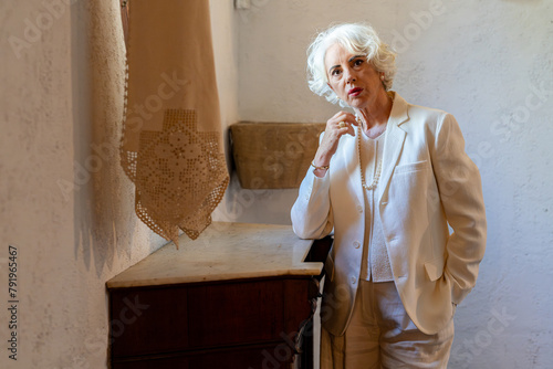 Portrait of a white-haired woman in her sixties dressed elegantly in fashion