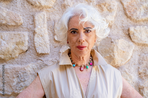 Portrait of a white-haired woman in her sixties dressed elegantly in fashion