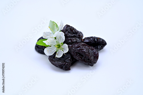 dried prunes and white plum flowers close-up