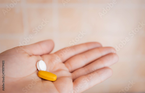 closeup woman hand holding medicine pills 