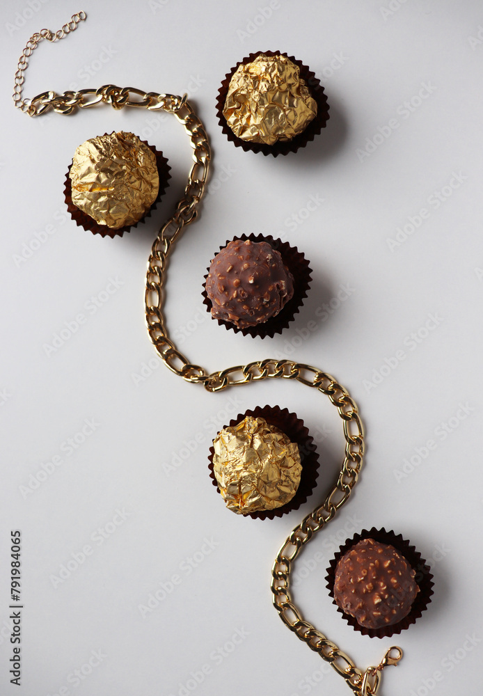 set of chocolates and a bouquet of yellow flowers on a white background set of chocolates and a bouquet of yellow flowers on a white background
