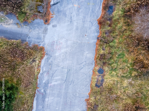 Aerial top down of graffiti road and forest during Fall around abandoned coal town Centralia Pennsylvania photo