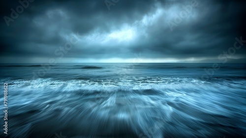  A vast expanse of water, with incoming waves caressing the shoreline, and a foreboding sky heavily laden with ominous clouds