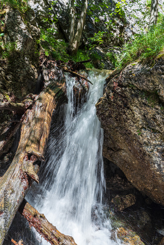 Waterfall between rocks in Janosikove diery in Mala Fatra mountains in Slovakia photo