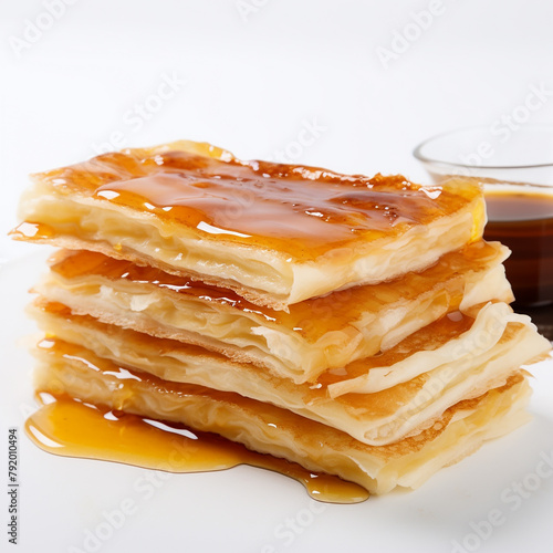 A stack of phyllo pastry with honey syrup on top photo