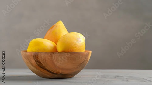 a ripe mango in a wooden bowl for advertisement and marketing purposes. fruit photography
