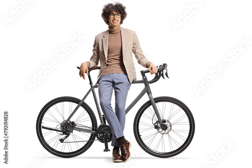 Young man sitting on a bicycle and looking at camera