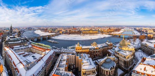 The Dresden and Elbe river cityscape covered in snow on a cold winter day in late afternoon.