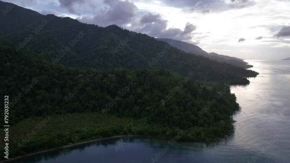 Early morning light illuminates the southern coast of Batanta in Raja Ampat, Indonesia. This remote, tropical region is known to harbor the world's greatest marine biodiversity. Early morning light illuminates the southern coast of Batanta in Raja Ampat, Indonesia. This remote, tropical region is known to harbor the world's greatest marine biodiversity.