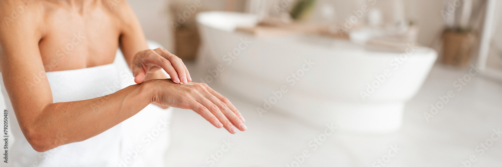 Unrecognizable middle aged woman applying hand cream, making beauty treatments Unrecognizable middle aged woman applying hand cream, making beauty treatments
