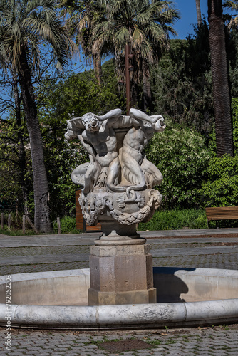 Triton Fountain (La fontaine des Tritons) in Nice Albert I Garden. Fountain consists of four tritons supporting a large bowl made of white marble. French riviera, Cote d'Azur, Nice, France.