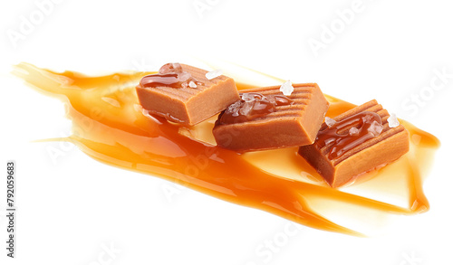 Salty caramel candies in milk caramel sauce with sea salt crystals isolated on a white background. Toffee candies.