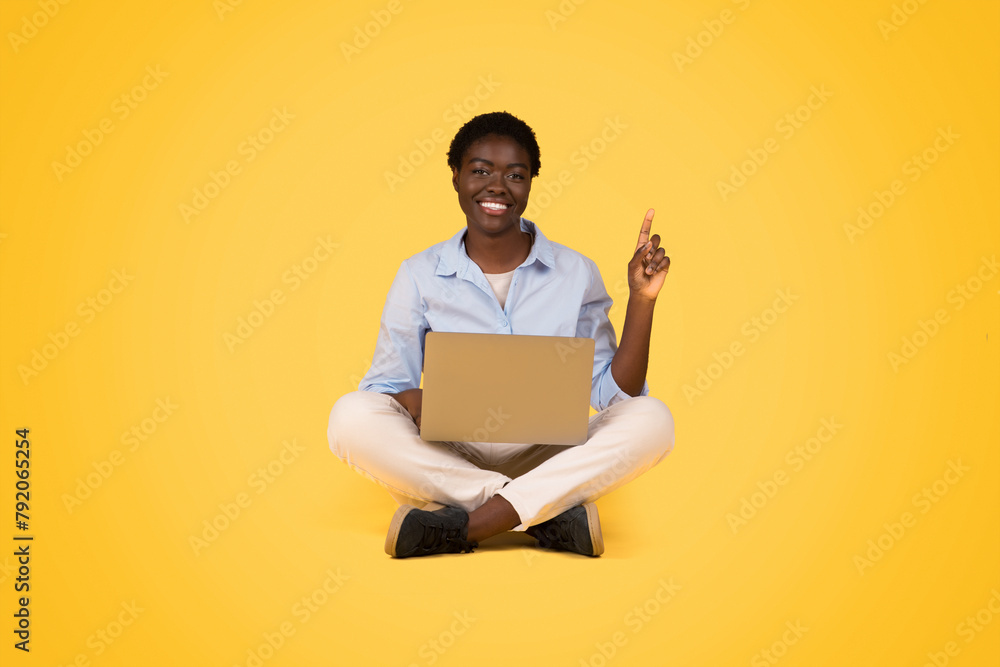 Woman sitting with laptop giving thumbs up Woman sitting with laptop giving thumbs up