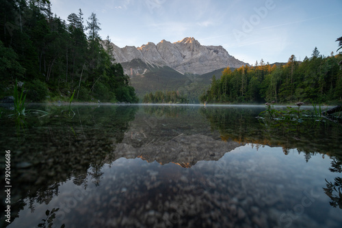Lake eibsee at dawn with still water reflection